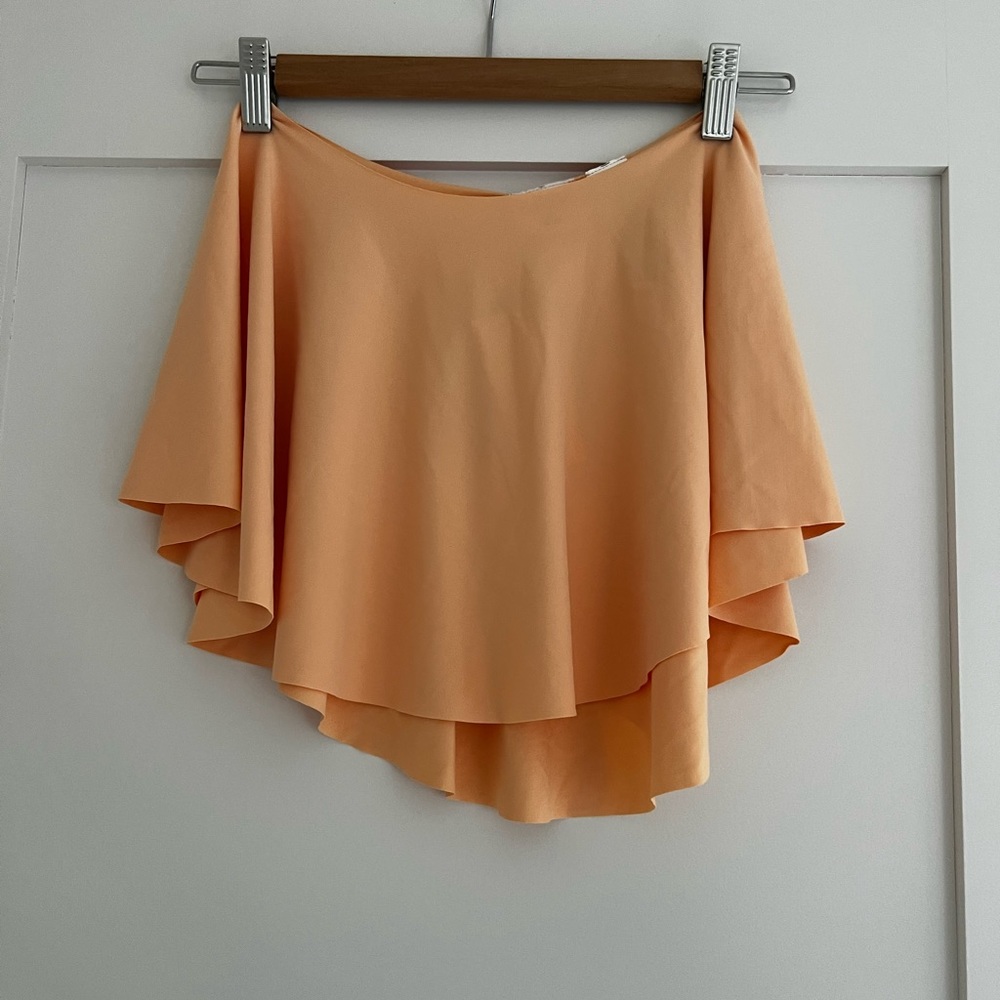 Capezio dancer circle skirt in creamy orange color. Size kids XL.